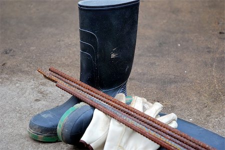 rebañar - a pair of rubber boots,a pair of work gloves and some re-inforcing bar Stock Photo - Budget Royalty-Free & Subscription, Code: 400-04503466