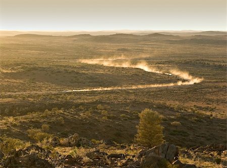 two cars leave plumes of dust as they go through the desert at sunset Stock Photo - Budget Royalty-Free & Subscription, Code: 400-04503512