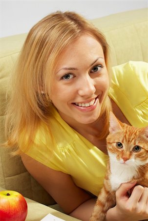 people laughing magazine - Embraces of the girl and kitten on a sofa Stock Photo - Budget Royalty-Free & Subscription, Code: 400-04514043