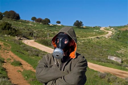 man with a gas mask and coat in landscape with winding path Stock Photo - Budget Royalty-Free & Subscription, Code: 400-04514675