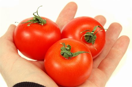 simsearch:614-06312094,k - tomatoes in hand isolated Stock Photo - Budget Royalty-Free & Subscription, Code: 400-04514792
