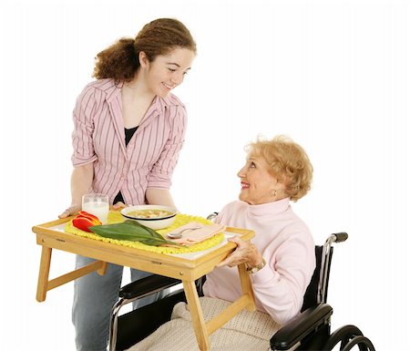 Teen volunteer serving soup to a disabled senior woman.  Isolated on white. Stock Photo - Budget Royalty-Free & Subscription, Code: 400-04515368