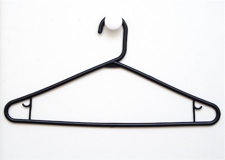 black plastic hanger against a white closet door Stock Photo - Budget Royalty-Free & Subscription, Code: 400-04516078