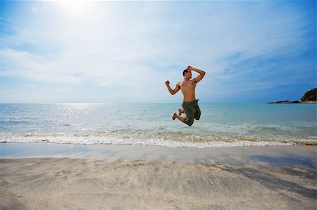 eyedear (artist) - happy man jumping excitedly by the beach Stock Photo - Budget Royalty-Free & Subscription, Code: 400-04516186