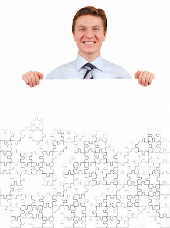 Smiling business man holding a white unfinished puzzle board  , add your text or image Stock Photo - Budget Royalty-Free & Subscription, Code: 400-04516905