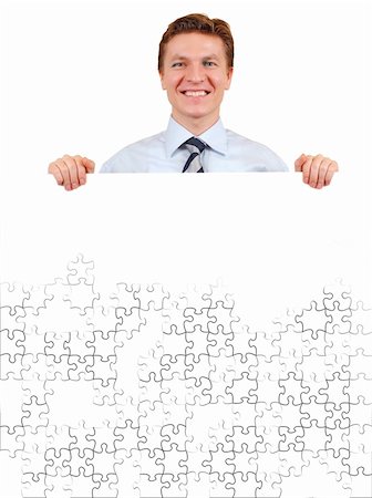 Smiling business man holding a white unfinished puzzle board  , add your text or image Stock Photo - Budget Royalty-Free & Subscription, Code: 400-04516906