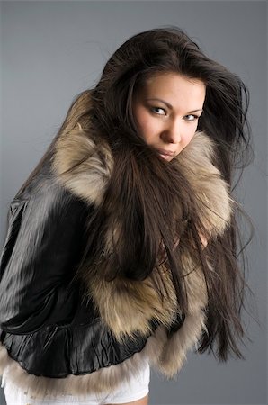 pretty girl with fur jacket in the wind looking cold Stock Photo - Budget Royalty-Free & Subscription, Code: 400-04516920