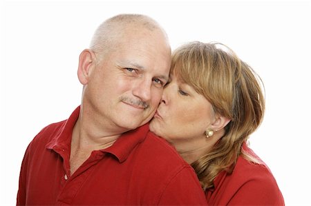 Happy middle aged man receiving a kiss from his wife.  Isolated on white. Stock Photo - Budget Royalty-Free & Subscription, Code: 400-04517299