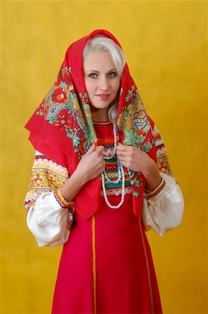 simsearch:400-05051542,k - a beautifull woman in a folk russian dress on yellow background Stock Photo - Budget Royalty-Free & Subscription, Code: 400-04518182