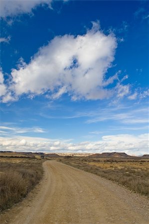 simsearch:400-05242063,k - Lonely road to desert under cloudy sky Photographie de stock - Aubaine LD & Abonnement, Code: 400-04518635