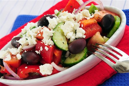 person eating greek salad - Greek salad with feta cheese and black kalamata olives Stock Photo - Budget Royalty-Free & Subscription, Code: 400-04519738