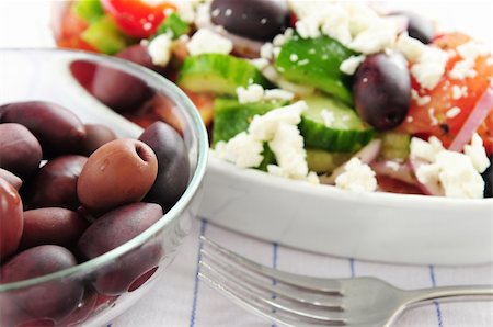 person eating greek salad - Black kalamata olives and greek salad with feta cheese Stock Photo - Budget Royalty-Free & Subscription, Code: 400-04519785
