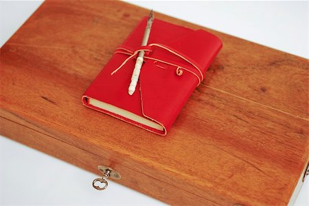 simsearch:400-04783872,k - An old wood box with a calligraphy pen on top and  leather red diary  on a white background Photographie de stock - Aubaine LD & Abonnement, Code: 400-04510117