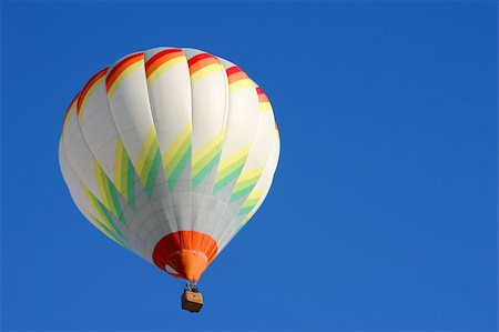 Hot air balloon in flight isolated on blue sky Stock Photo - Budget Royalty-Free & Subscription, Code: 400-04510209