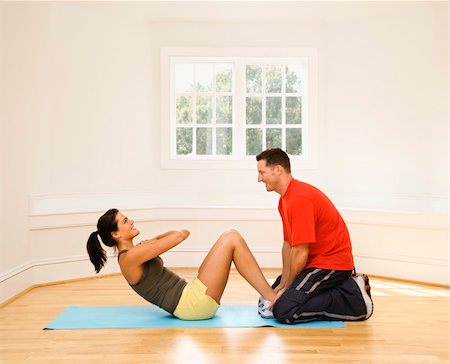 Man holding woman's feet down as she does sit up exercises. Stock Photo - Budget Royalty-Free & Subscription, Code: 400-04510247