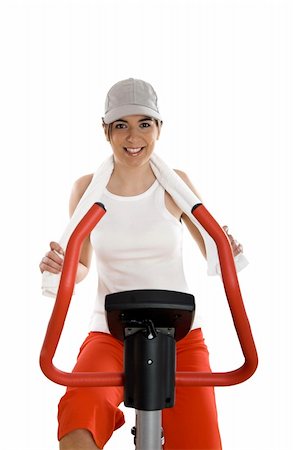 simsearch:400-04027186,k - Young woman training on exercise bike at the gym Stockbilder - Microstock & Abonnement, Bildnummer: 400-04510369