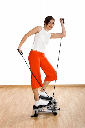 simsearch:400-07627460,k - Beautiful young woman making exercise on the gym Photographie de stock - Aubaine LD & Abonnement, Code: 400-04510375