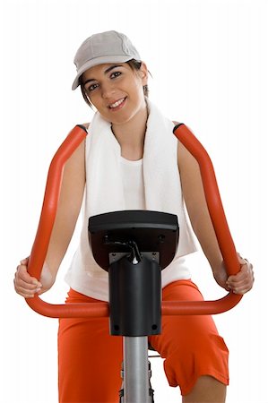 simsearch:400-04027186,k - Young woman training on exercise bike at the gym Stockbilder - Microstock & Abonnement, Bildnummer: 400-04510370