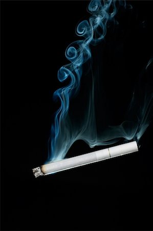 Smoking cigarette and blue smoke on the black background Stock Photo - Budget Royalty-Free & Subscription, Code: 400-04510786