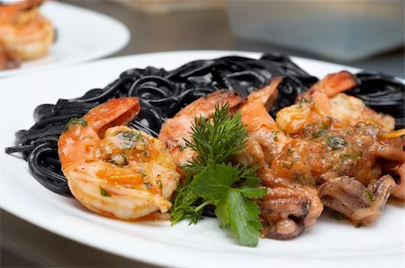 shrimp black - fried shrimps with exotic black spaghetti tinted by cuttlefish ink Stock Photo - Budget Royalty-Free & Subscription, Code: 400-04511029