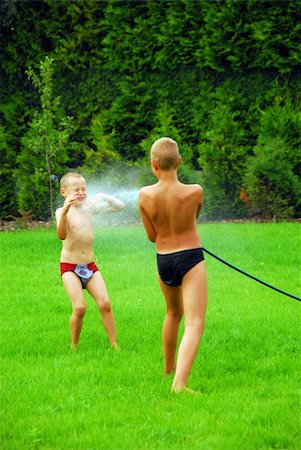 simsearch:400-05875962,k - two boys play on the grass near house Photographie de stock - Aubaine LD & Abonnement, Code: 400-04511022