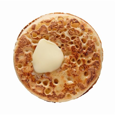 buttered crumpet, shot from the top, isolated Foto de stock - Super Valor sin royalties y Suscripción, Código: 400-04511077