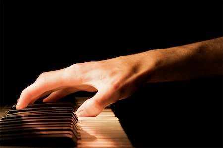piano practice - Caucasian male's hand playing the piano Stock Photo - Budget Royalty-Free & Subscription, Code: 400-04511251
