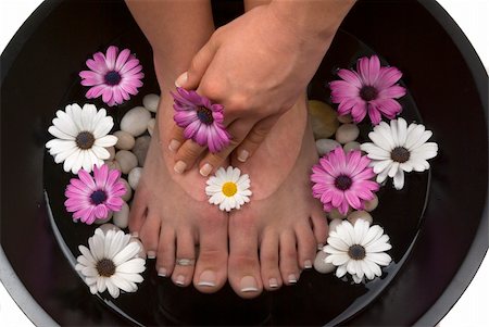 foot daisy - Beautiful pedicured feet and manicured hand with colorful spring daisies in a spa Stock Photo - Budget Royalty-Free & Subscription, Code: 400-04511629