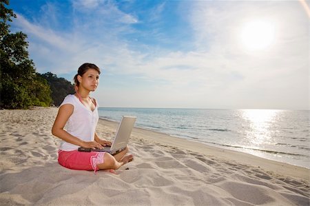 eyedear (artist) - woman working on laptop while relaxing on a beautiful beach during summer Stock Photo - Budget Royalty-Free & Subscription, Code: 400-04511904