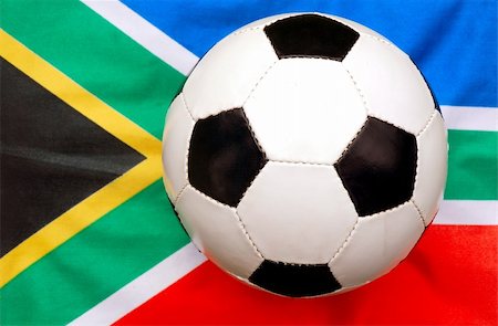 A traditional black and white soccer ball on the national flag of South Africa for the FIFA football worldcup 2010 Photographie de stock - Aubaine LD & Abonnement, Code: 400-04511936