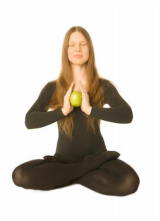 simsearch:400-04596923,k - The portrait of a woman in lotus pose with a green apple in her hands Stock Photo - Budget Royalty-Free & Subscription, Code: 400-04511965