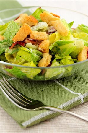 Fresh caesar salad with croutons and bacon bits served in a glass bowl Stock Photo - Budget Royalty-Free & Subscription, Code: 400-04513141