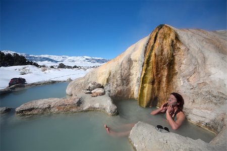 simsearch:400-05015574,k - A woman applies mud to her face in a natural hot spring pool in California. Stock Photo - Budget Royalty-Free & Subscription, Code: 400-04513327