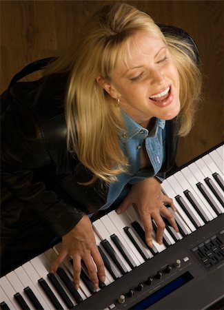 piano practice - Female Musician Sings While Playing Digital Piano Stock Photo - Budget Royalty-Free & Subscription, Code: 400-04513567