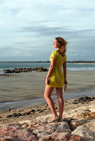 The young girl in a yellow dress on a coast of ocean Foto de stock - Super Valor sin royalties y Suscripción, Código: 400-04513956