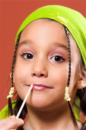 young pretty child applying make-up Stock Photo - Budget Royalty-Free & Subscription, Code: 400-04524100