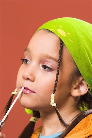 young pretty child applying make-up Stock Photo - Budget Royalty-Free & Subscription, Code: 400-04524101
