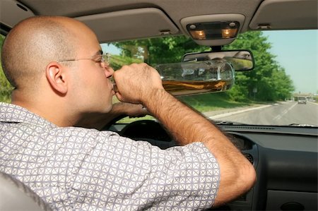 simsearch:400-04947548,k - Drunk man sitting in drivers sit and drinking from a bottle Stock Photo - Budget Royalty-Free & Subscription, Code: 400-04524234