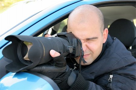 simsearch:400-04880707,k - Professional photographer in action with telephoto lens, paparazzi Foto de stock - Royalty-Free Super Valor e Assinatura, Número: 400-04524239