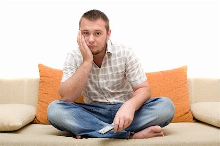 simsearch:400-04540885,k - casualman sitting on sofa with remote control Foto de stock - Royalty-Free Super Valor e Assinatura, Número: 400-04525360