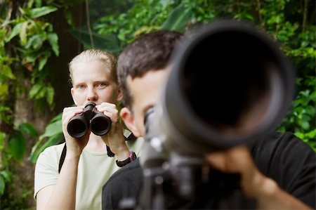 Pretty Woman with Binoculars and Man with Telescope in Rain Forest Jungle Foto de stock - Super Valor sin royalties y Suscripción, Código: 400-04525669