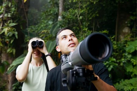 simsearch:400-04729405,k - Pretty Woman with Binoculars and Man with Telescope in Rain Forest Jungle Photographie de stock - Aubaine LD & Abonnement, Code: 400-04525670