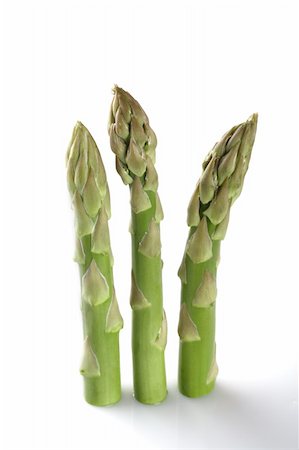 three asparagus spears standing over white backgrond with light shadow Foto de stock - Royalty-Free Super Valor e Assinatura, Número: 400-04525949