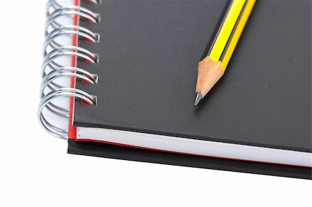 simsearch:400-03912552,k - Pencil on a one notebook with soft shadow on white background. Shallow depth of field Stockbilder - Microstock & Abonnement, Bildnummer: 400-04525993