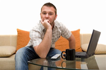 simsearch:400-04540351,k - happy man on sofa with laptop Stock Photo - Budget Royalty-Free & Subscription, Code: 400-04526354