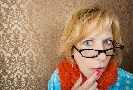 Crazy woman with glasses suspiciouly eyeing the camera Foto de stock - Royalty-Free Super Valor e Assinatura, Número: 400-04526580