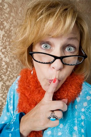Crazy woman with glasses putting her finger to her lips Foto de stock - Royalty-Free Super Valor e Assinatura, Número: 400-04526581