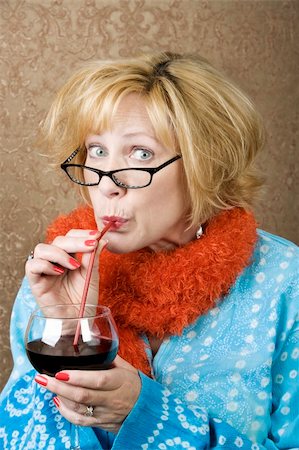 Funny woman drinking wine through a straw Foto de stock - Royalty-Free Super Valor e Assinatura, Número: 400-04526676