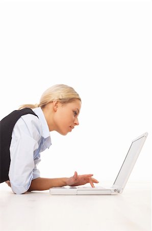 simsearch:400-05729276,k - Businesswoman working on her laptop while lying down on the floor Stock Photo - Budget Royalty-Free & Subscription, Code: 400-04526713