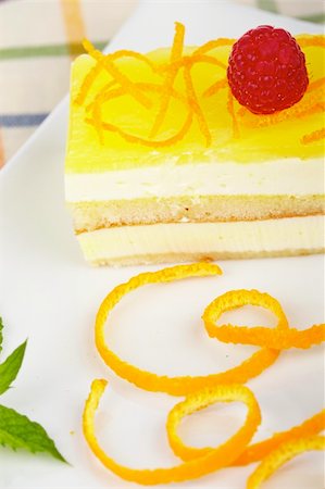 simsearch:400-05347658,k - Delicious lemon cake with soft shadow on white dish. Shallow depth of field Photographie de stock - Aubaine LD & Abonnement, Code: 400-04527032